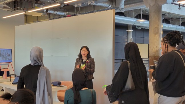 Group of youth on a field trip listening to the speaker